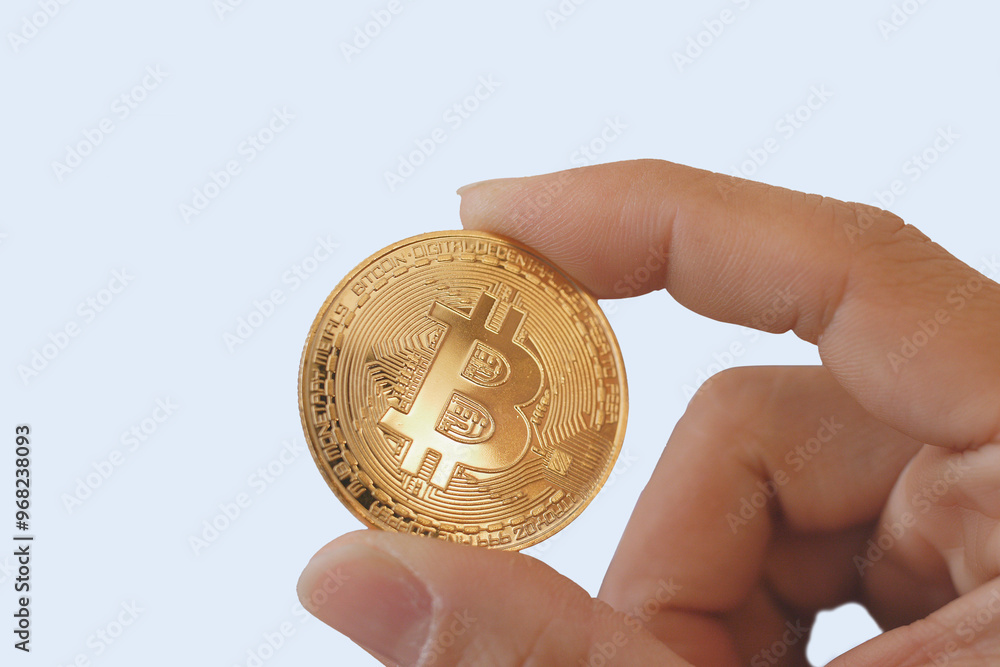 Cryptocurrency, finance and business concept, hand holding golden bitcoin over white background Cryptocurrency, finance and business concept, hand holding golden bitcoin over white background