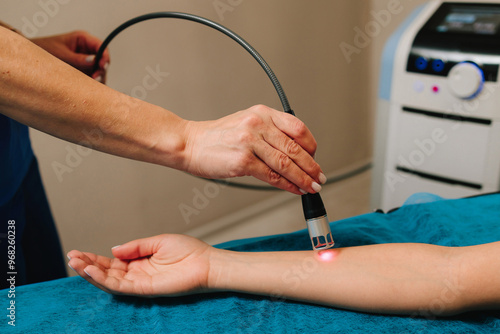 Hand low level laser therapy to promote healing of soft tissues. Infrared treatment of hand to manage pain, numbness and tingling. Doing laser therapy to improve blood flow and immune system.