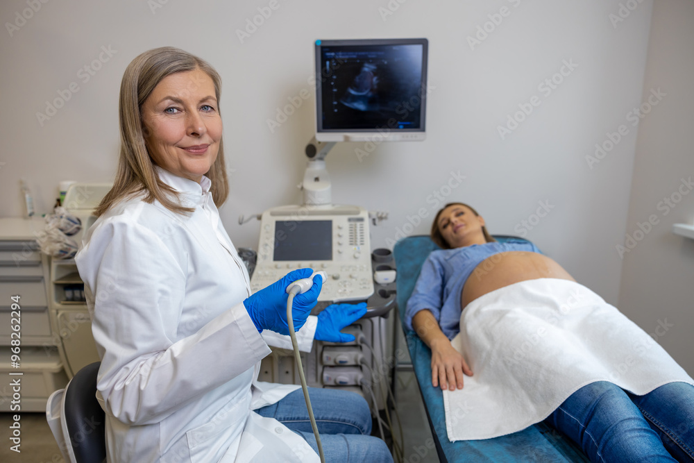 Pregnant woman lying on a couch in clinic while ultrasonography Pregnant woman lying on a couch in clinic while ultrasonography