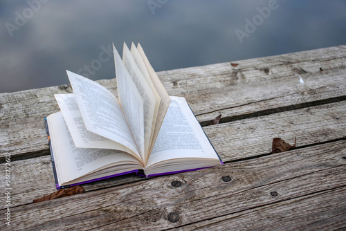 Foto Open book with pages flipping in the wind