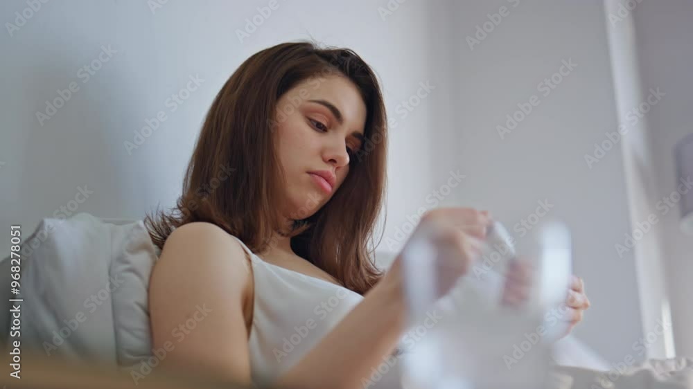 Sad lady measuring temperature in comfortable home bed closeup. Frustrated woman Sad lady measuring temperature in comfortable home bed closeup. Frustrated woman
