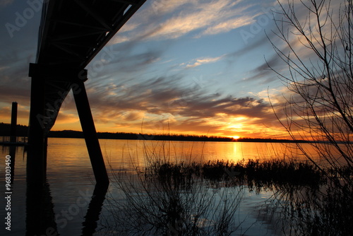 View of a sunset over the Columbia River with a pier in the foreground