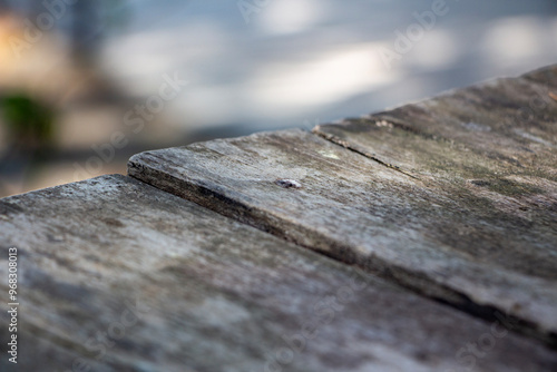 Wooden table in the park, selective focus, vintage tone. Wooden plank close up photo. Wooden texture.