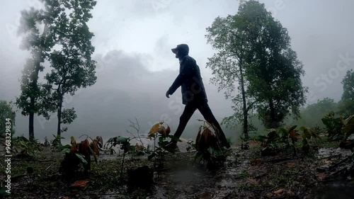 silhouette of a person walking on mountains  meanwhile raining.
