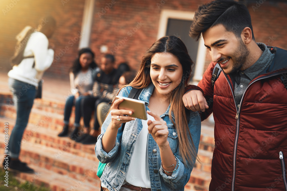 Obraz premium Happy couple, students and watching with phone for social media, communication or streaming at campus. Young, man and woman with smile and backpack on mobile smartphone for online browsing at college