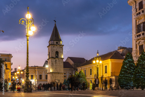 Photos Evening in Historic Town Square (Benevento - Italy)
A twilight scene featuring a historic church tower and warmly lit street lamps, inviting visitors to explore the charm of the old town