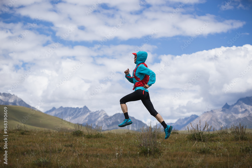 Fitness woman trail runner running in grassland Fitness woman trail runner running in grassland