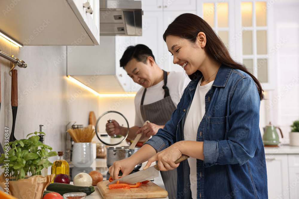 Happy lovely couple cooking together in kitchen Happy lovely couple cooking together in kitchen