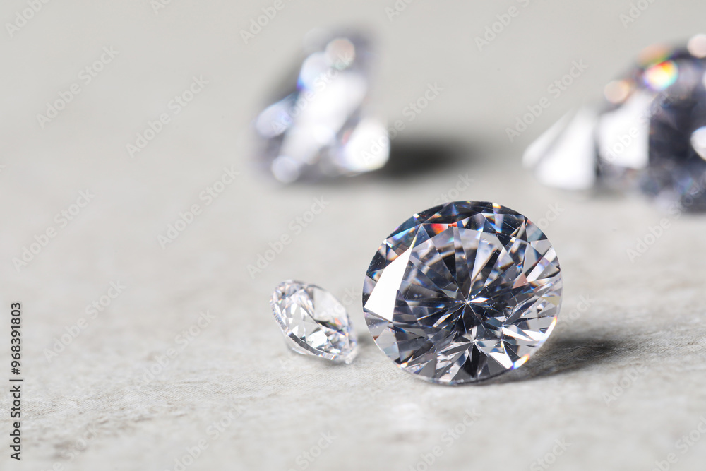 Many beautiful shiny diamonds on light background, closeup Many beautiful shiny diamonds on light background, closeup