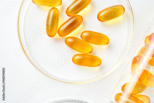 Petri dish with fish oil capsules inside, vitamin D, omega softgels, supplements, keto diet.