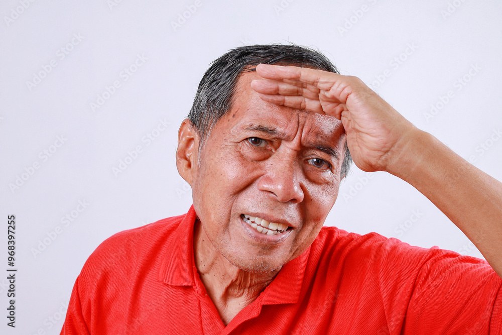 Fototapeta premium Senior asian man hold hand at forehead look far away distance isolated on white background