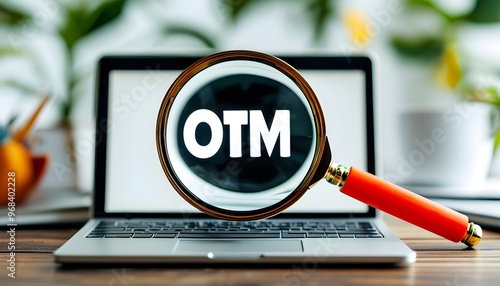 Magnifying OTM Word on Laptop Display with White Background photo