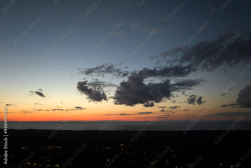 Dramatic sunset sky covered with colorful yellow clouds over dark ground. Panoramic skyscape Dramatic sunset sky covered with colorful yellow clouds over dark ground. Panoramic skyscape