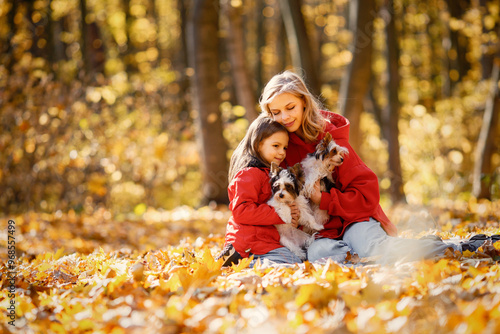 Photography Mother and daughter sitting on a blanket in autumn forest with dogs