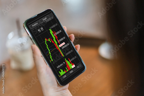 Wallpaper Mural Hand hold smartphone with stock market chart financial trading, online investment, stock exchange analysis, market trends, real-time trading data, forex and crypto trading economic forecasting tool Torontodigital.ca