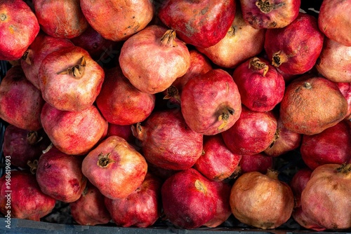 Fresh Red Pomegranates in a Market Stall