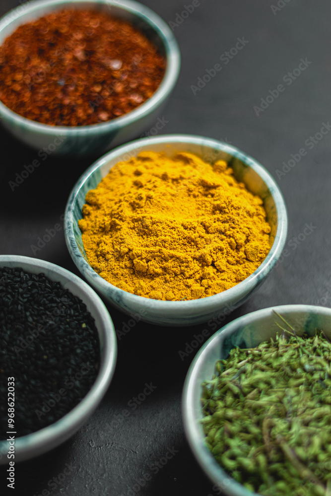 Traditional oriental spices in ceramic bowls. black cumin seed, ground red pepper, dried mint, himalayan salt. Traditional oriental spices in ceramic bowls. black cumin seed, ground red pepper, dried mint, himalayan salt.