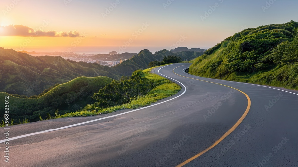 Naklejka premium A winding road through lush green hills at sunset, offering a tranquil and scenic view for travelers and nature enthusiasts.