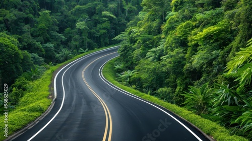 A winding road through lush greenery, capturing the beauty of nature and the serenity of a tranquil journey.