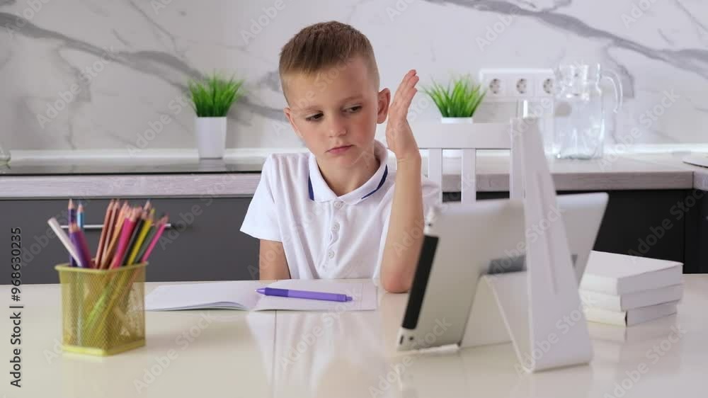 School boy studying at home, doing homework with laptop. Distance online learning. Back to school. One more question to be answered. School boy studying at home, doing homework with laptop. Distance online learning. Back to school. One more question to be answered.