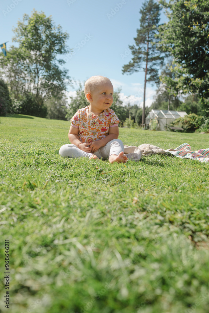 Surface level of baby girl sitting on grassy field Surface level of baby girl sitting on grassy field