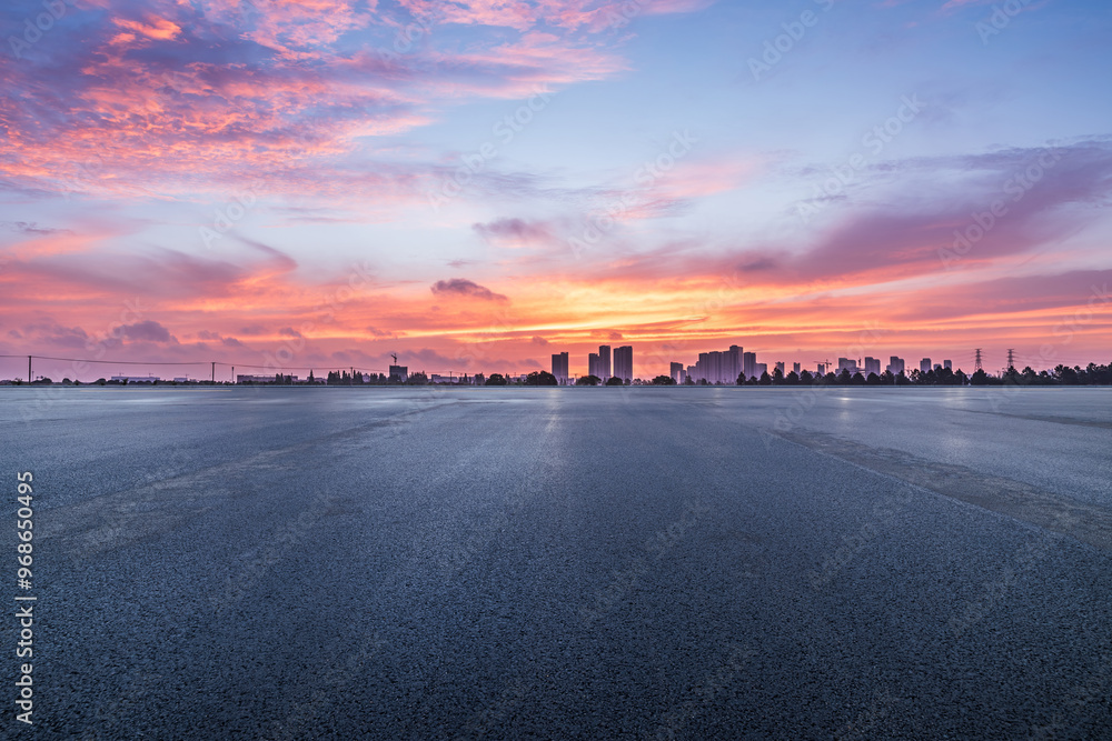Asphalt road square and skyline with beautiful sky clouds at sunrise. car background.