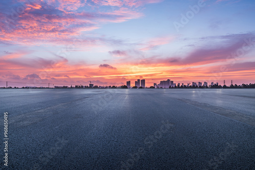 Obraz na płótnie Asphalt road square and skyline with beautiful sky clouds at sunrise. car background. w salonie