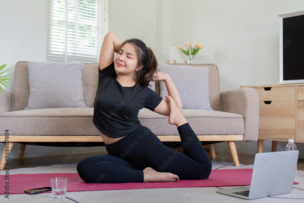 Woman practicing yoga pose with laptop guidance at home Woman practicing yoga pose with laptop guidance at home