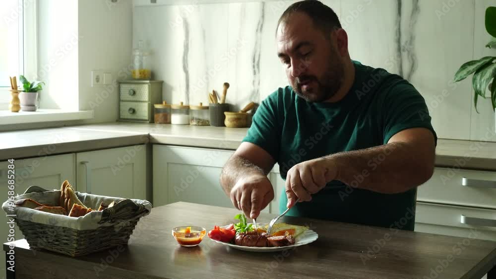Man eats english breakfast at home Man eats english breakfast at home