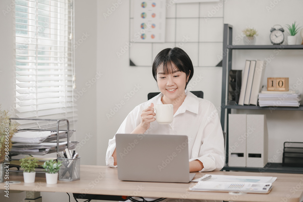 Focused businesswoman tackling tasks on laptop in a bustling office Focused businesswoman tackling tasks on laptop in a bustling office