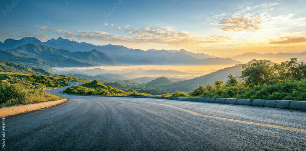 Asphalt road is winding through green hills during golden hour sunrise over a misty valley. High quality photo Asphalt road is winding through green hills during golden hour sunrise over a misty valley. High quality photo