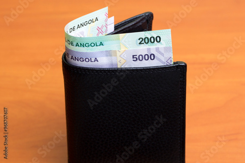 Angolan Kwanza in the black wallet photo