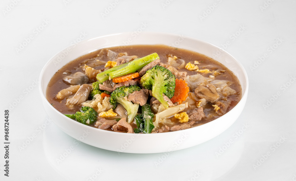 Delicious mixed vegetable and meat stir-fry in a white bowl, featuring fresh broccoli, carrots, and hearty chunks of meat. Delicious mixed vegetable and meat stir-fry in a white bowl, featuring fresh broccoli, carrots, and hearty chunks of meat.