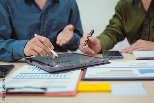 Close-up of a businessman in a meeting at the office discussing topics related to digital marketing management, financial analysis, business writing, teaching, and venture capital investments.