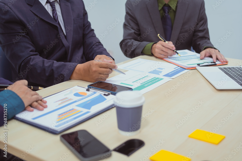 Close-up of a businessman in a meeting with a group of businessmen in the office, discussing digital marketing strategies, financial data analysis, and planning business projects together. Close-up of a businessman in a meeting with a group of businessmen in the office, discussing digital marketing strategies, financial data analysis, and planning business projects together.