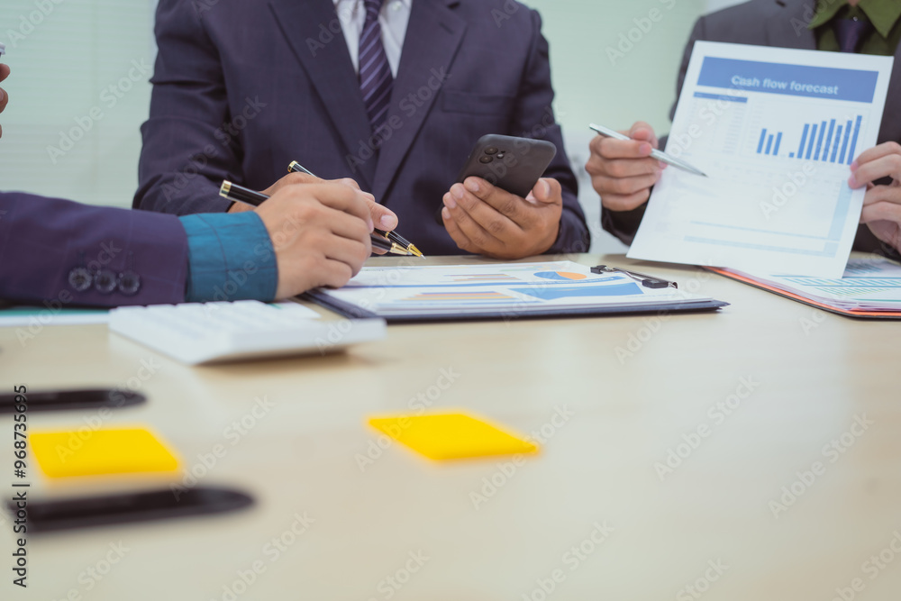 Close-up of a businessman in a meeting with a group of businessmen in the office, discussing digital marketing strategies, financial data analysis, and planning business projects together. Close-up of a businessman in a meeting with a group of businessmen in the office, discussing digital marketing strategies, financial data analysis, and planning business projects together.