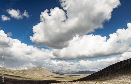 Clouds and curvilinear landscapein in the natural park of Deosai photo