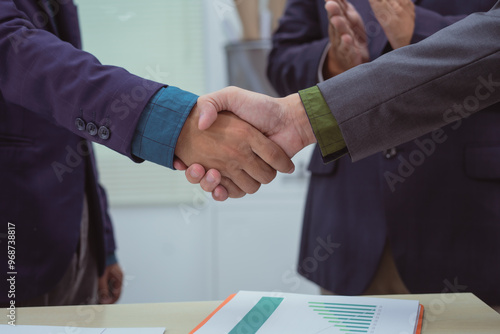 Wallpaper Mural Close-up of business people shaking hands during a meeting in the office, discussing and analyzing charts,financial data,planning digital marketing projects together with business experts investors Torontodigital.ca
