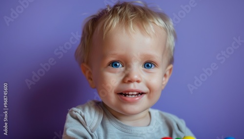 Cute little boy with blue eyes and blond hair, adorable toddler with captivating blue eyes and curly blonde hair stares in wonder and surprise, innocence and curiosity of childhood