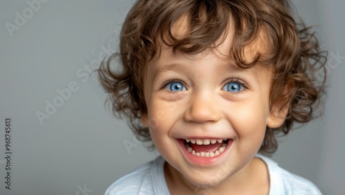 Cute little boy with blue eyes and blond hair, adorable toddler with captivating blue eyes and curly blonde hair stares in wonder and surprise, innocence and curiosity of childhood