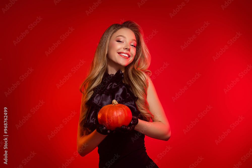 Lovely pretty youth girl hold pumpkin for decorating halloween party wear black goth style dress Lovely pretty youth girl hold pumpkin for decorating halloween party wear black goth style dress