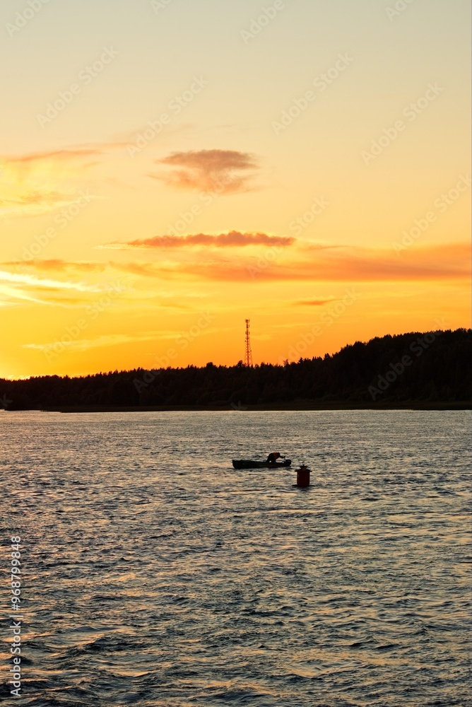 A boat at a navigation mark at sunset. A boat at a navigation mark at sunset.