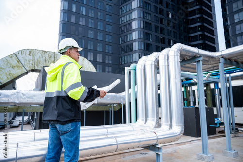 The technician carefully inspecting a section of pipeline during a construction project, emphasizing safety and precision in infrastructure development.