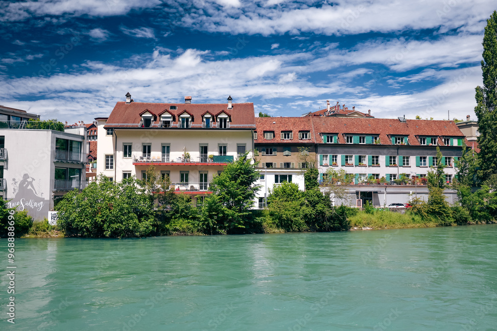 Beautiful riverfront buildings along the Aare in Bern, Switzerland, showcasing stunning architecture on a sunny day Beautiful riverfront buildings along the Aare in Bern, Switzerland, showcasing stunning architecture on a sunny day