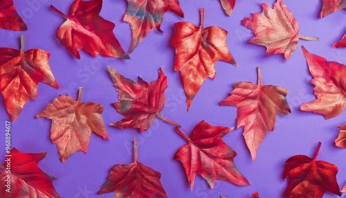 Pattern of dry orange metallic leaves on purple background