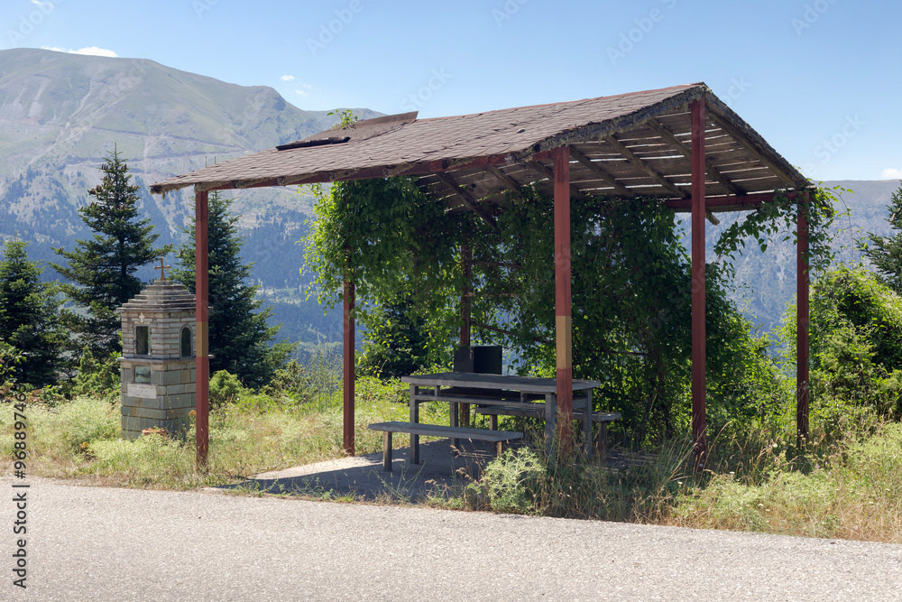 Wooden gazebo in the mountains near the mountain road (Central Greece) Wooden gazebo in the mountains near the mountain road (Central Greece)