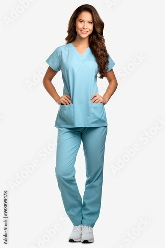 Full body shot of a friendly female nurse in blue scrubs smiling confidently