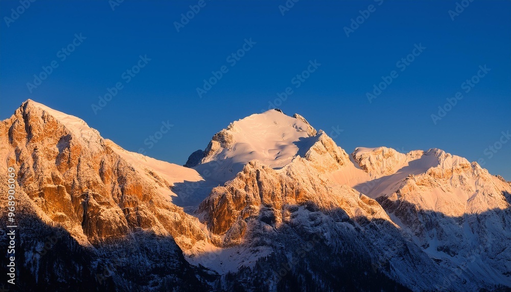 Majestic snow-capped mountain peaks under a clear blue sky in winter Majestic snow-capped mountain peaks under a clear blue sky in winter