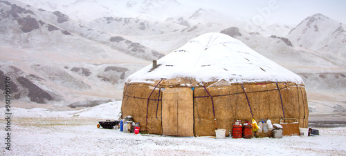 Yurts in winter. National ancient house of the peoples of Kyrgyzstan and Asian countries. national housing. Yurts against the backdrop of snow and highlands. Yurt camp for tourists. photo