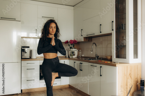 Yoga at home during pregnancy and problems with getting a knee injury. Pregnant woman on Vorkuta holds on to a sprain on her leg, exercises to prepare for childbirth photo